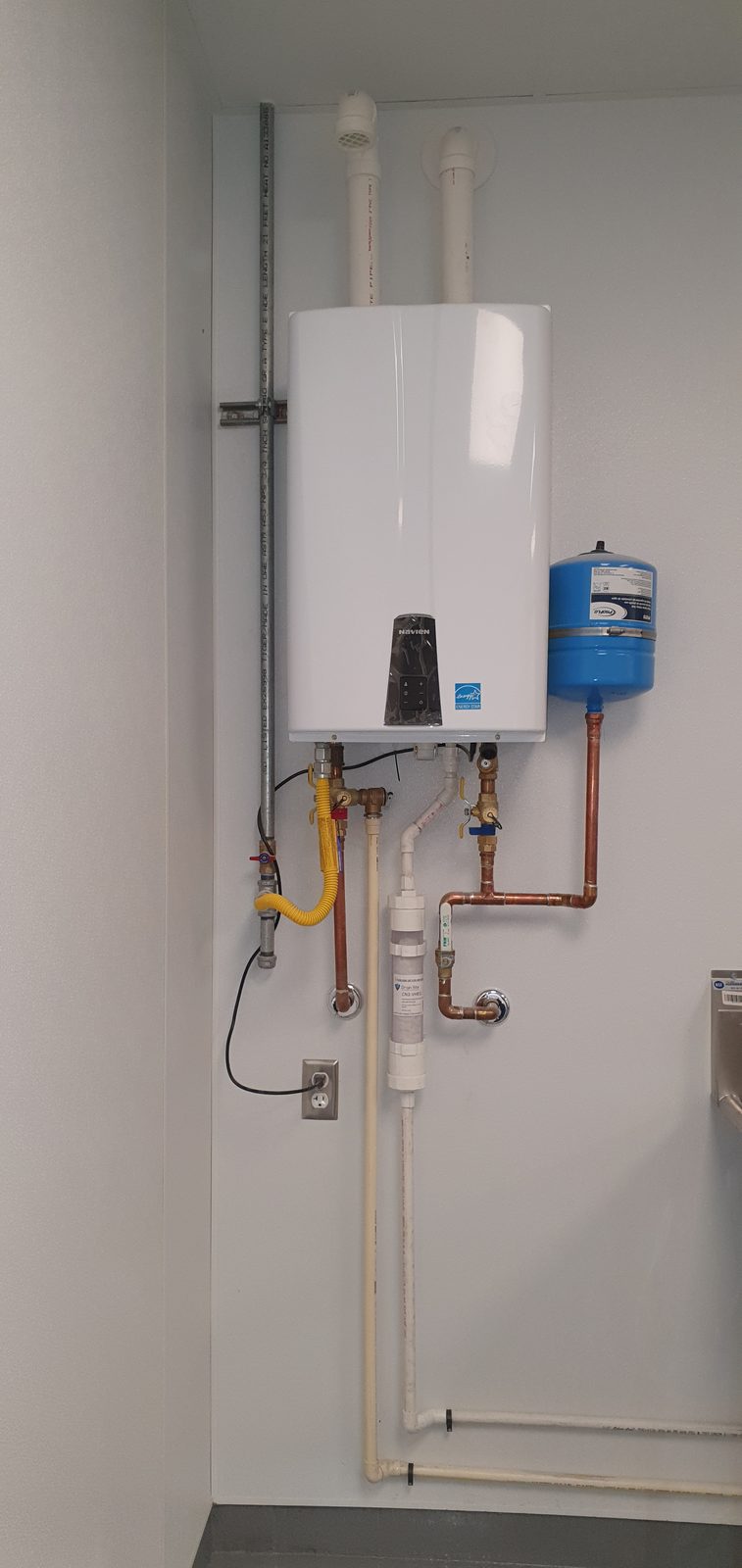 Navien high-efficiency tankless water heater installed with expansion tank and copper connections